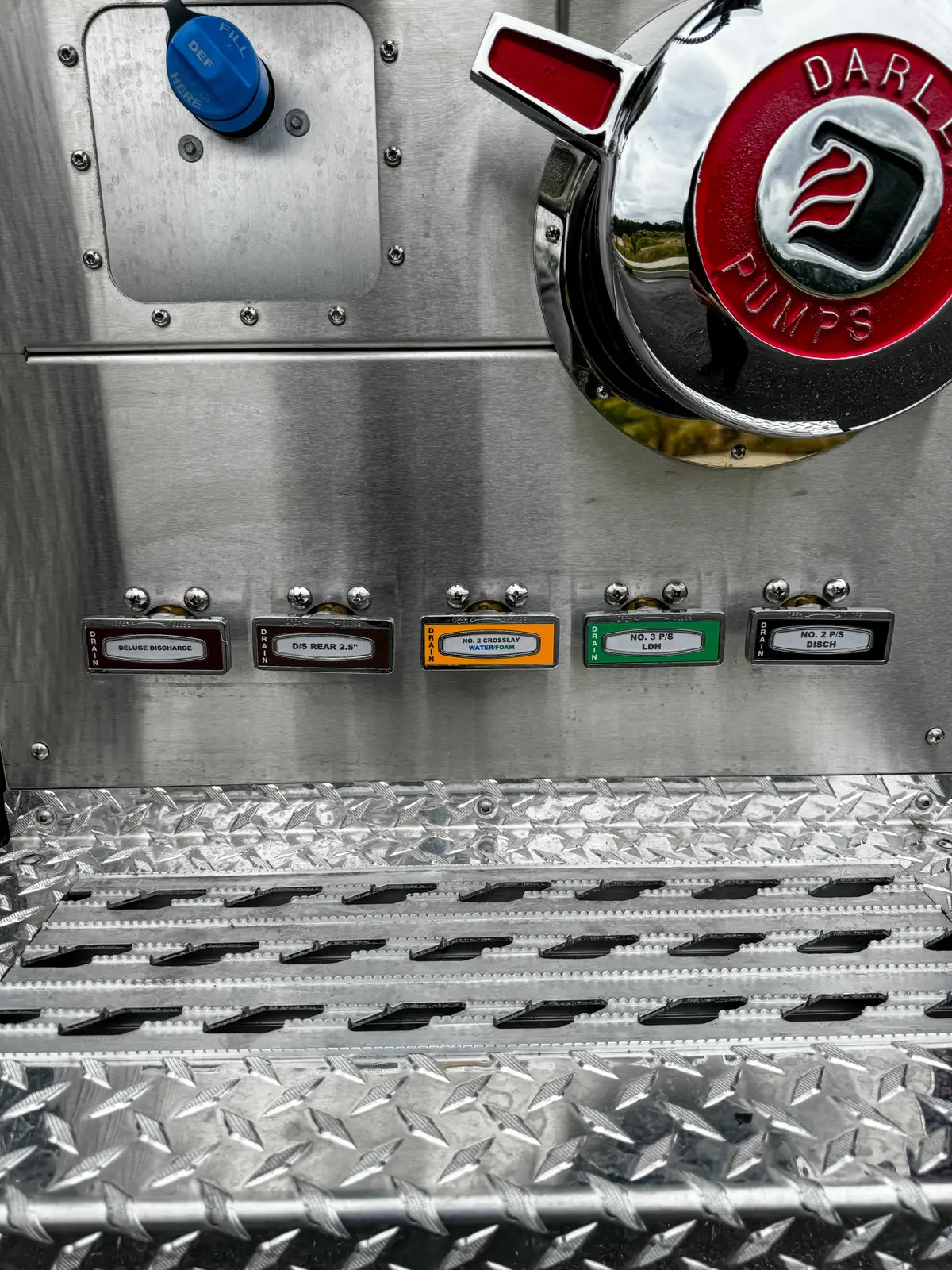 Pump-service compartment close-up showing valves, lines, and mounted hardware.